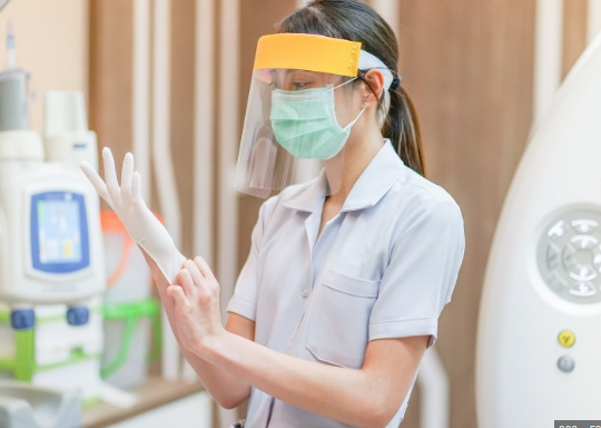 Woman in Dental Office, OSHA Safety Regulations